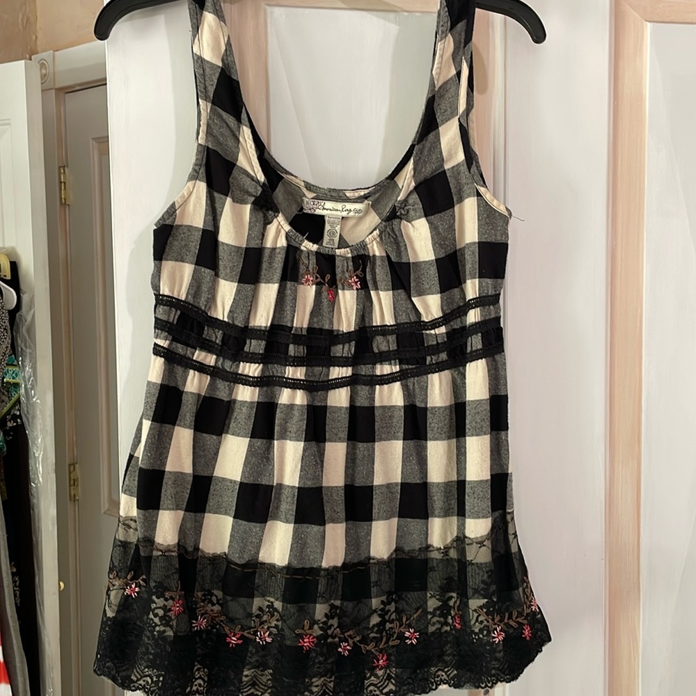 American rag size medium sleeveless top with lace design at bottom 100% cotton